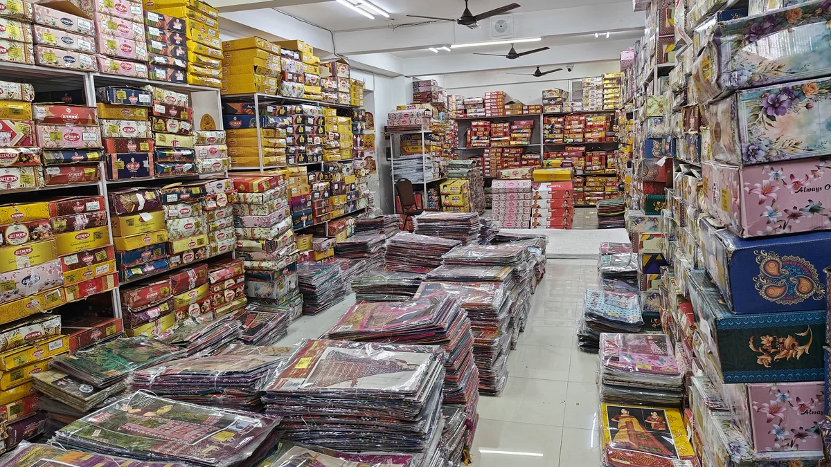 Floor-to-ceiling cotton saree stock at Santosh Synthetics Jamshedpur — bulk wholesale inventory for Ranchi retailers