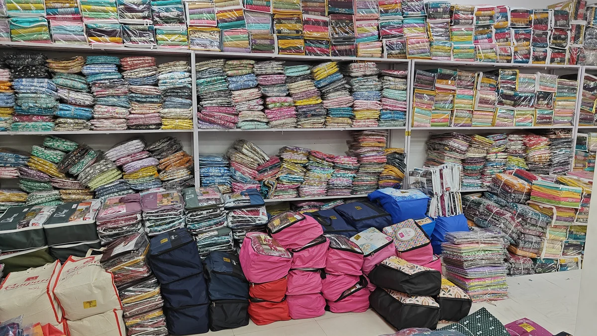 Wholesale ladies suit unstitched dress material wall shelves at Santosh Synthetics for Ranchi clothing retailers